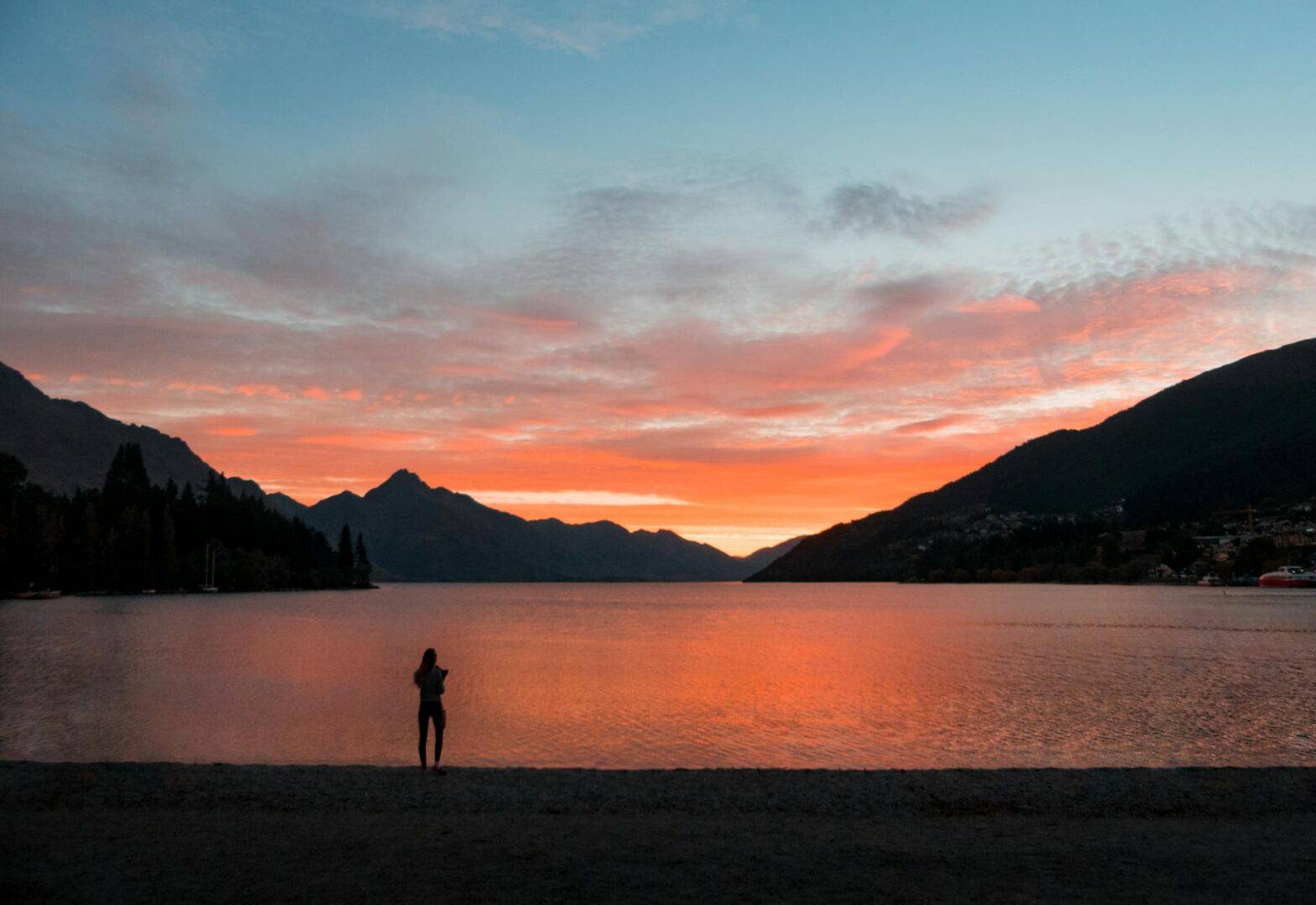 digital nomad standing near body of water